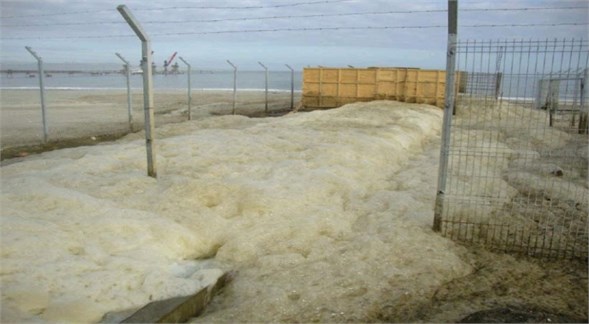 Foam generated from outfall spreads over nearby coast (Angamos, Chile)