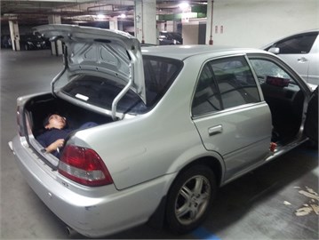 A person hiding in the trunk of the car