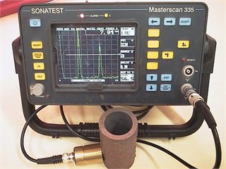 a) EMAT transducer coupled with a popular standard UT instrument MS335 and  b) the manual EMAT thickness measurement performed on boiler tubes