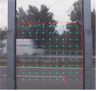 a) Panel of noise barrier with measurement lattice on LDV screen captured during “in situ” measurements of vibrations, and b) an example of the road noise barrier panel vibrations  obtained by author for frequency 0.75 Hz