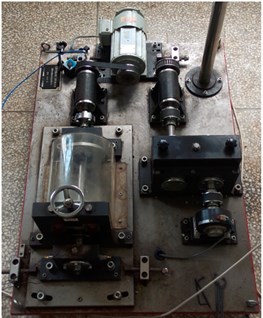 a) Test rig of QPZZ-II, b) faulty rolling element bearing with bearing housing