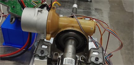 The standard a) and modified electric power steering column with composite housing  of the worm gear b) during laboratory tests