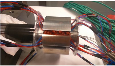 a) Thermoelectric modules and temperature sensors integrated into the bearing bush;  b) general view of the test rig and its control system