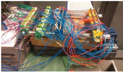 a) TECs and thermocouples wiring connected to the control module;  b) NI's modules that generate PWM signals