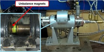 a) Test rig, b) opened hatch to mount unbalance magnets
