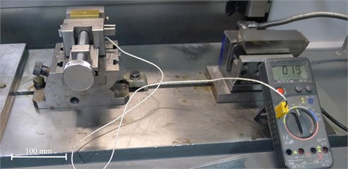 Digital multimeter with connected thermocouple (the tip of thermocouple placed  in the outlet hole of the workpiece at a distance from 0 up to 3 mm from the grinded surface)