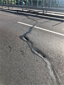 The subsidence of the subgrade caused the road surface to crack