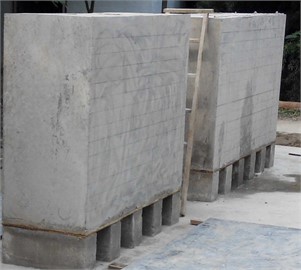 Preparation of experimental concrete slabs: a) constructing the concrete specimen mold;  b) the concrete slab specimens after they have been poured