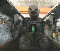 Implementation of the testing process: a) test loads of different weights;  b) placement of the loads onto the locomotive frame using a crane