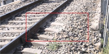 The depression that forms close to the bridge as the result of the crushed stone in the ballast layer at the crossing section. The photograph, taken by the second author on August 25, 2025, illustrates issues with the road superstructure in the transition zone from the earthwork to the bridge
