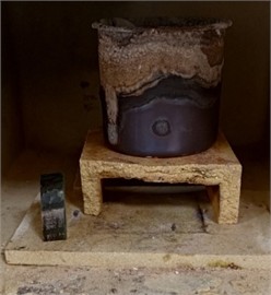 Sample and steel crucible in the muffle furnace. Photo taken by M.Z. Ubaydullaev (co-author) in the laboratory of the Almalyk Branch of NUST MISIS, 2025