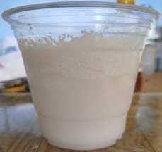 Verification of film-forming materials: a) type of film-forming material with expired shelf life, sprayed on the surface of freshly laid cement concrete; b) separation of film-forming material and formation of particles larger than 1 mm. Photograph taken by Tukhtayev Matchon Bekjonovich in the laboratory and on field test sections of newly constructed cement concrete pavement, Tashkent, Uzbekistan