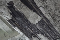 Concrete beams of the bridge span structure: a), b) defects in concrete bridge beams  in the form of exposure, active corrosion, and broken wire strands; c) view of the outer beams  of the bridge, reinforced with MMA-adhered external reinforcement