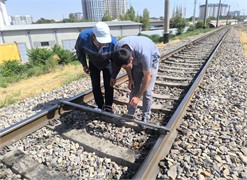Inspection of bridge transition and rail joint zones as the main object of the study. The photograph, taken by the third author during research conducted in 2024-2025, depicts the processes of measuring and monitoring the railway bridge transition and rail joint zones using the SUP-3 track gauge template