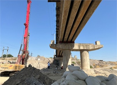 Bridge’s photo and photo of the monitoring studies in progress: a) photo of the bridge, b) photo of monitoring studies in progress. The photos were taken by S. Takhirov on May 30, 2025