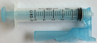 Becker and syringe used to measure the resin volume