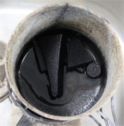 Oil quenching process. Photo by the authors in the laboratory  of the Almalyk Branch of NUST MISIS 2026