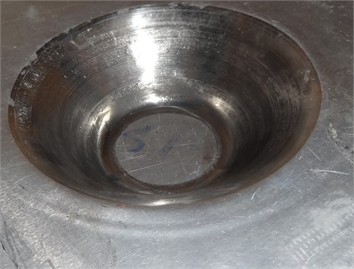 a) Geometry of the formed hyperbolic part, b) laminated sheet after performing the SPIF process
