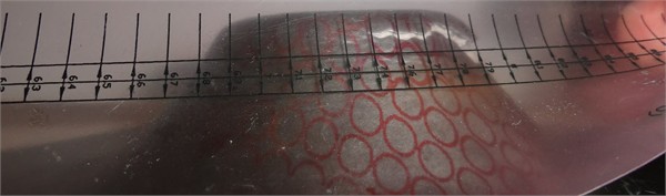 Strain measurement using the calibrated measuring strip applied to formed test samples
