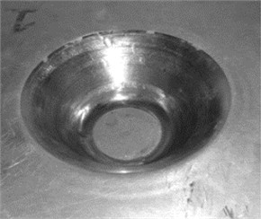 a) Laminated sheet formed by SPIF on the CNC milling machine; b) circular grid pattern on the formed sheet, used to measure the strains in the necked zone