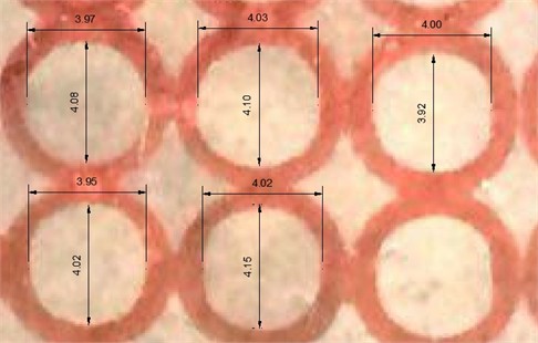 a) Undeformed circular grid measured in AutoCAD 2010, showing the reference diameters (nominally 4 mm) used as L₀ in the strain calculation; b) the calibrated flexible strip used to measure grid dimensions along the curvilinear wall. Principal strains were evaluated as ε=lnLL0 with L0= 4, the printed grid diameter, and L the corresponding major or minor axis of the deformed ellipse